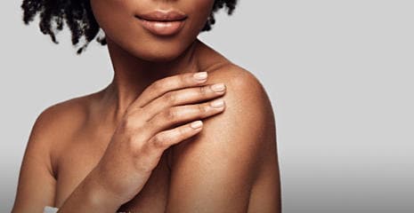 Young woman touching her skin after using Bepanthen Derma Gentle Body Cleanser
